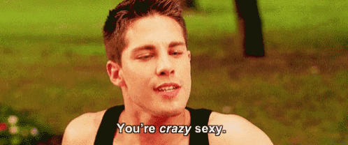 a young man in a black tank top is saying `` you 're crazy sexy . ''
