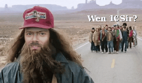 a man with a beard wearing a red hat that says ' forrest gump '