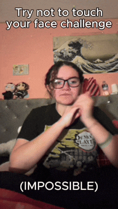 a girl wearing glasses and a t-shirt that says demon slayer