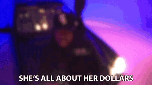 a blurry picture of a car with the words `` she 's all about her dollars '' written in the corner .