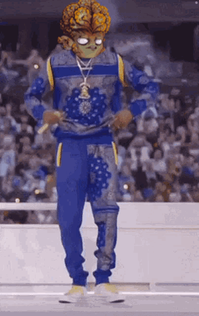 a man wearing a blue sweater and blue pants is dancing