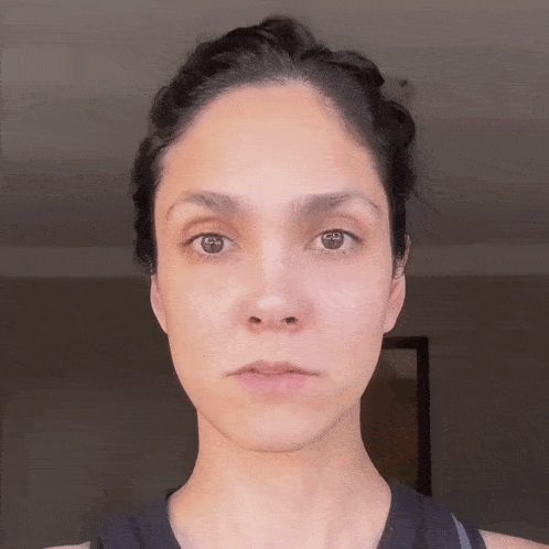 a close up of a woman 's face without makeup .