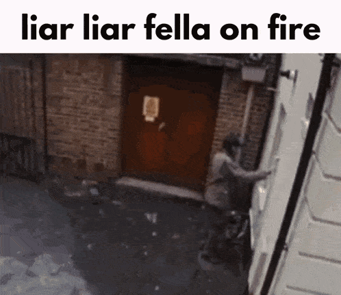 a man climbs up a building with the words liar liar fella on fire below him