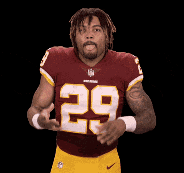 a man in a redskins jersey with the number 29 on his chest