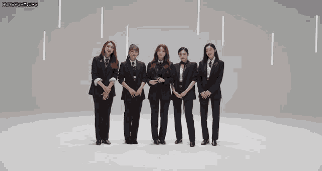 a group of women in suits are standing next to each other on a white background