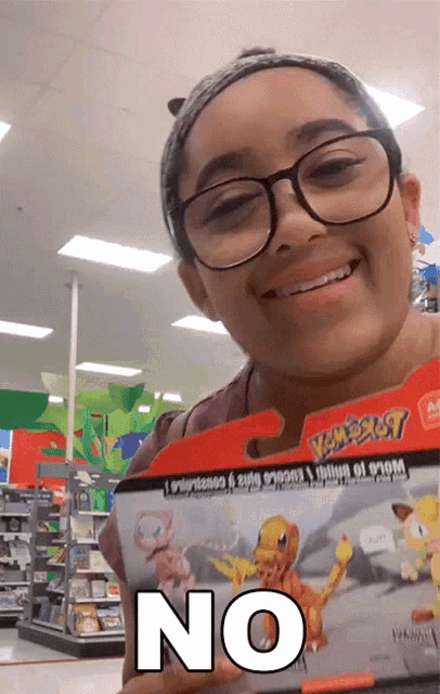 a woman holding a pokemon toy with the word no on it