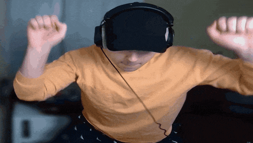 a man wearing headphones and a hat dancing