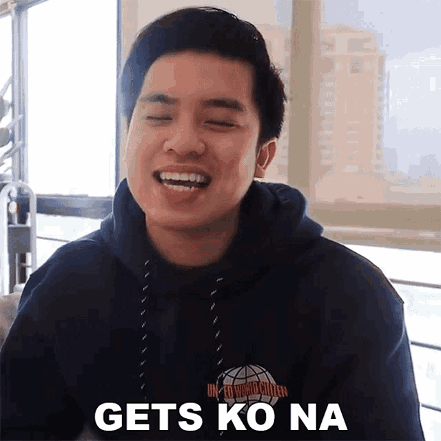 a man wearing a hoodie with the words gets ko na on it