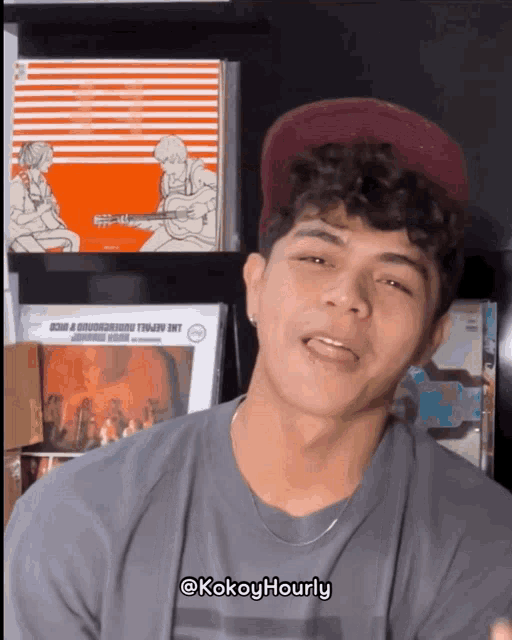 a young man wearing a hat and a shirt that says kokoyhourly
