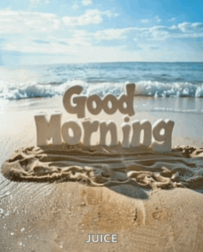 a sandy beach with the words " good morning " written in the sand