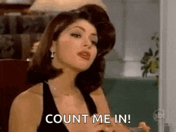 a woman in a black dress is sitting in front of a lamp and says `` count me in '' .