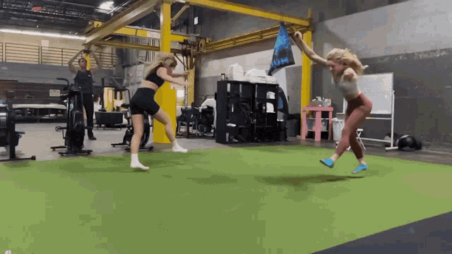 a woman is jumping in the air while holding a bag that says ' u.m. ' on it