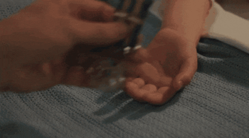 a close up of a person holding a medal in their hands