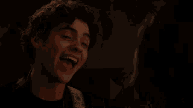 a close up of a woman 's face in a dark room