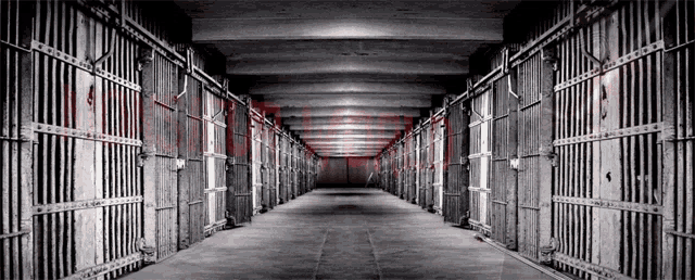 a black and white photo of a jail cell with the word prison written on the bottom