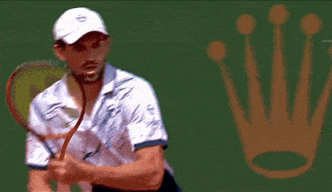 a tennis player is playing in front of a rolex sign