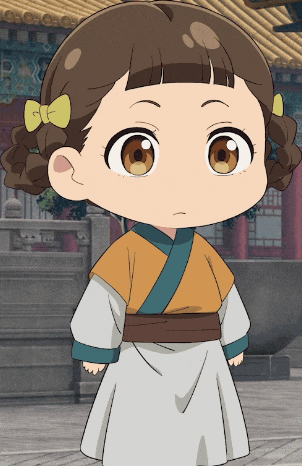 a little girl with a yellow bow in her hair is standing in front of a building