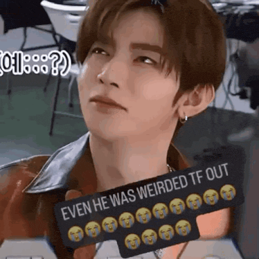 a close up of a person holding a sign that says `` even he was weirded tf out '' .