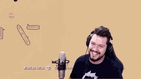 a man wearing headphones is smiling in front of a microphone that says marcar local l