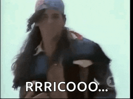 a man with long hair is wearing a baseball cap and a jacket and says rrricoo .