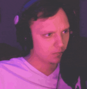 a man wearing headphones and a white shirt is making a face .
