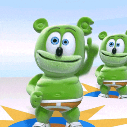 two green gummy bears are standing next to each other waving
