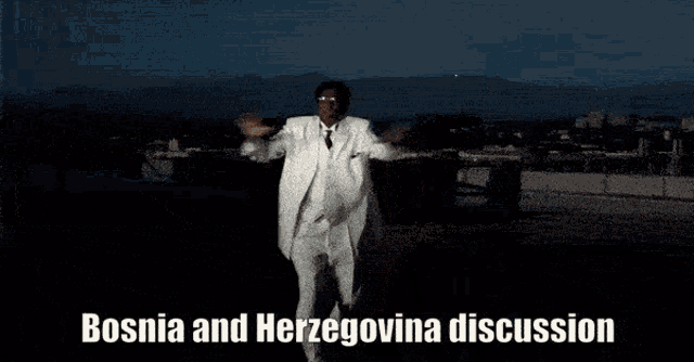 a man in a white suit is dancing with the words bosnia and herzegovina discussion behind him