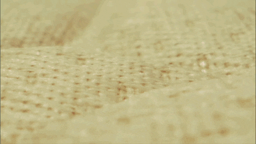 a close up of blood on a carpet with a spoon in it