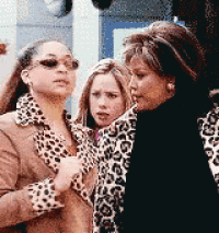three women are standing next to each other wearing leopard print jackets