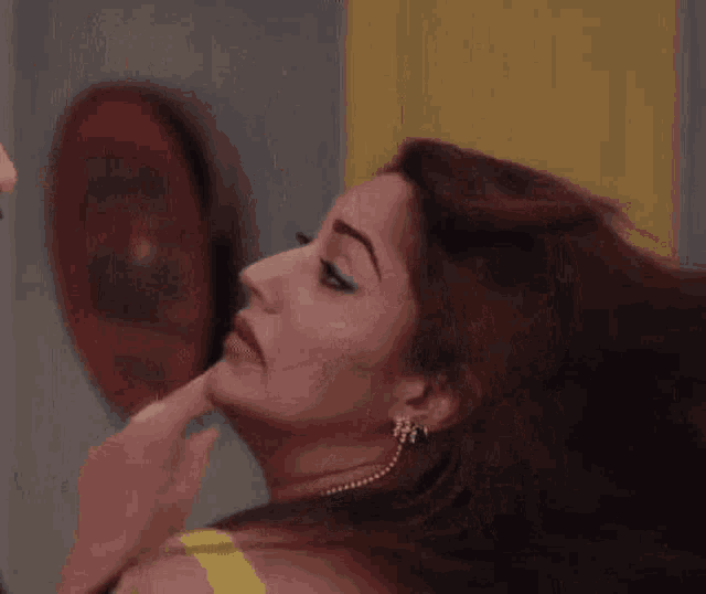 a close up of a woman 's face with a man 's face in the background .