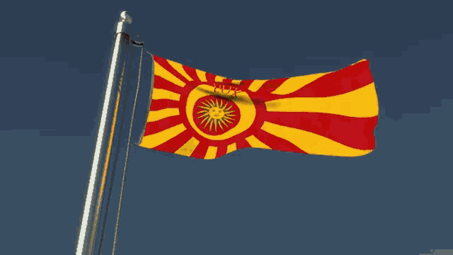 a yellow and red flag with the words ultima lux on it