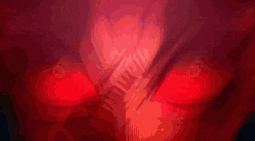 a close up of a person 's eyes with red lights
