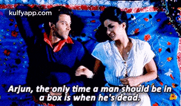 a man and a woman are laying on a bed and the man is saying that the only time a man should be in a box