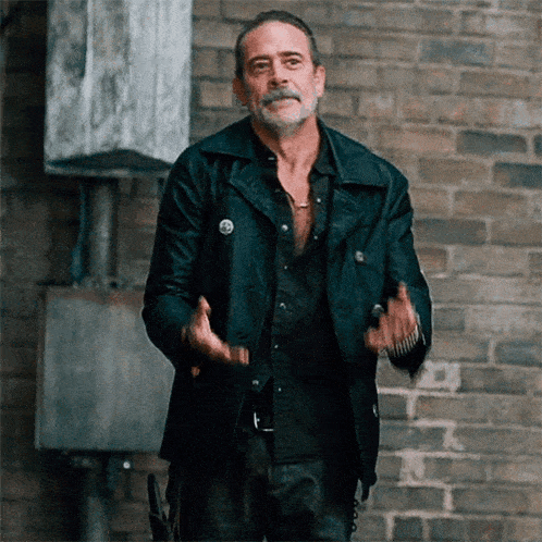 a man with a beard wearing a black leather jacket