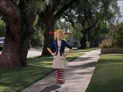 a girl standing on a sidewalk wearing red white and blue striped socks