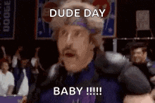 a man wearing a headband and a purple shirt is standing in a crowd and says `` dude day baby '' .