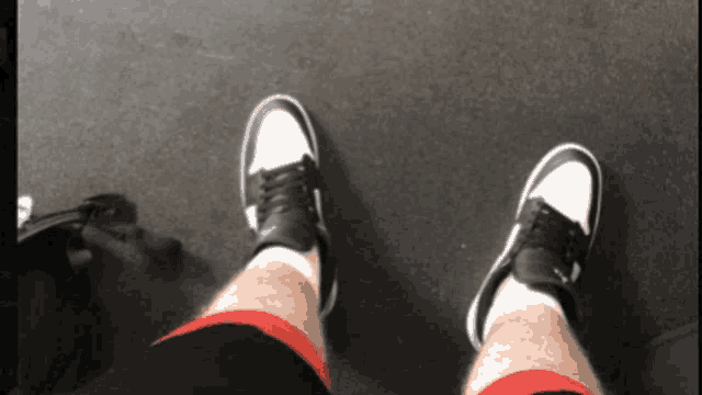 a person wearing a pair of black and white nike shoes