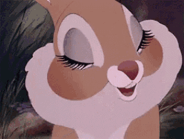 a close up of a bunny with its eyes closed