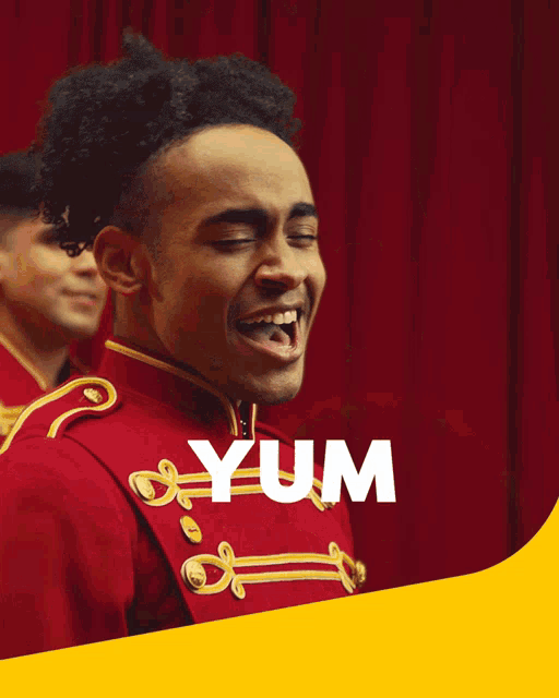 two men in red uniforms are laughing with the word yumm in white