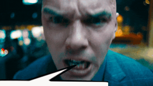 a close up of a man 's face with his mouth open