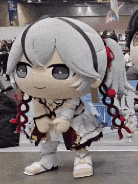 a stuffed doll is standing in front of a sign that says " meet ryan square "