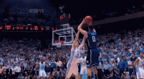 a basketball player with the number 0 on his jersey is jumping for the basketball