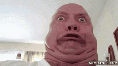 a man is making a funny face with his neck .