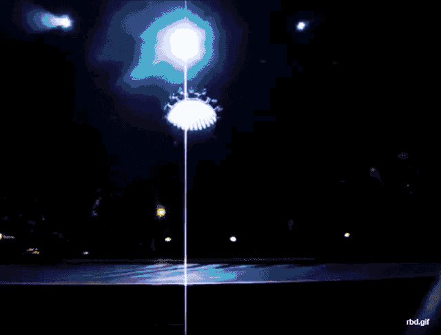 a person is standing on a stage with a blue light behind them and the words rbd.gif on the bottom