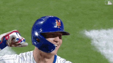 a baseball player wearing a blue helmet with a ny logo on it