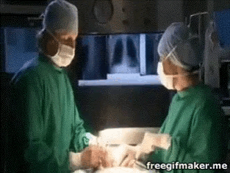 a surgeon and a nurse in an operating room with a freegifmaker.me logo in the corner