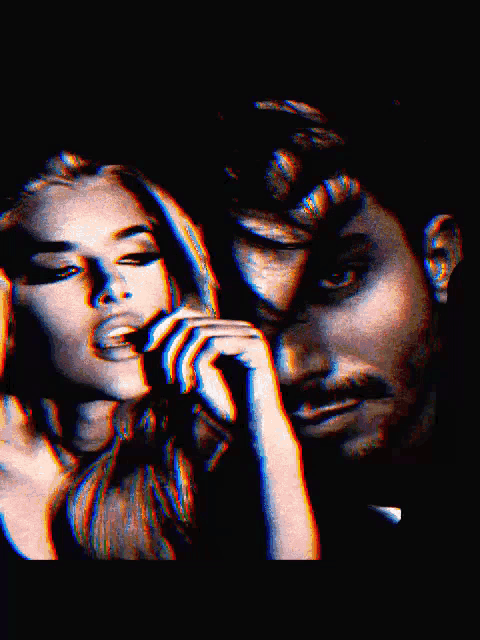 a man and a woman are looking at each other