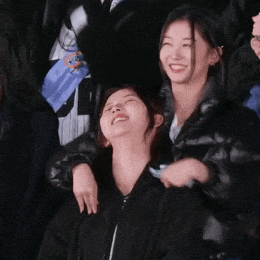 a group of girls are posing for a picture and one of them is laughing