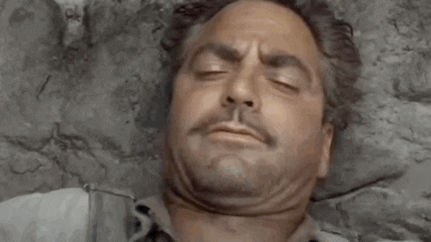 a man is laying on a bed with his eyes closed and the words `` good morning '' written above him .