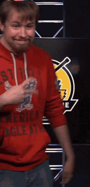 a man wearing a red american eagle shirt